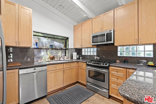 kitchen featuring wooden ceiling, vaulted ceiling with beams, stainless steel appliances, and tasteful backsplash