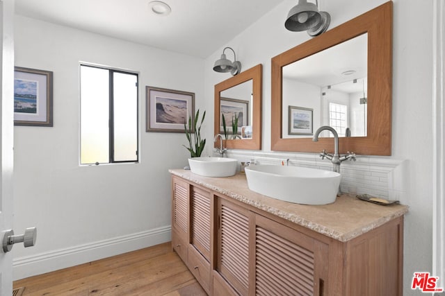 bathroom featuring backsplash, vanity, and hardwood / wood-style floors