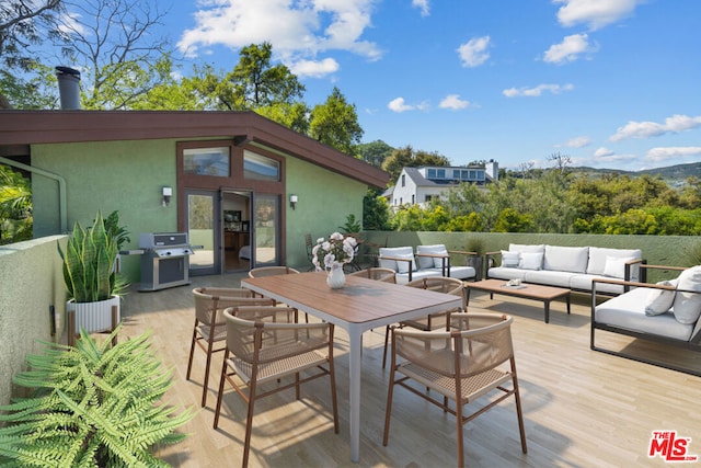 view of patio / terrace featuring outdoor lounge area, area for grilling, and a wooden deck