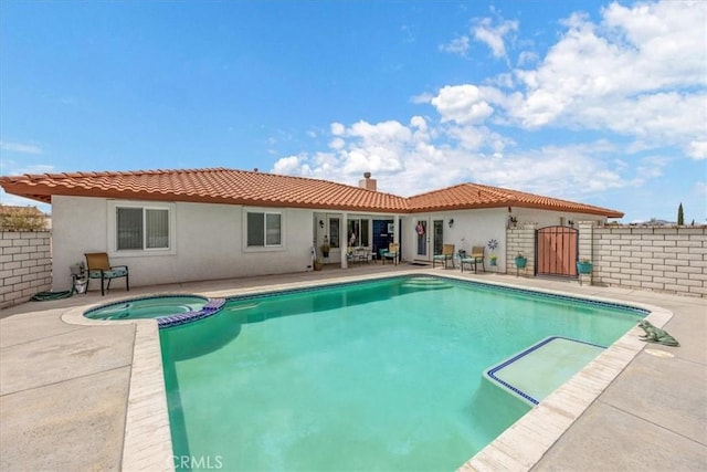 view of pool with an in ground hot tub and a patio