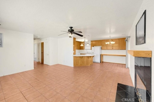 unfurnished living room with ceiling fan with notable chandelier