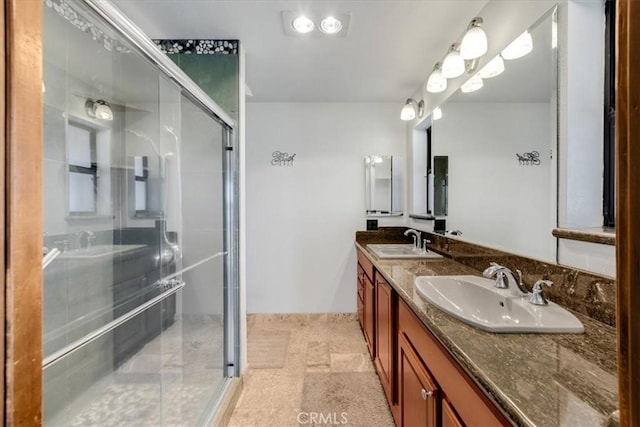 bathroom with a shower with door and vanity