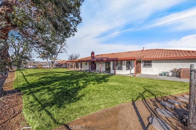 rear view of house with a yard