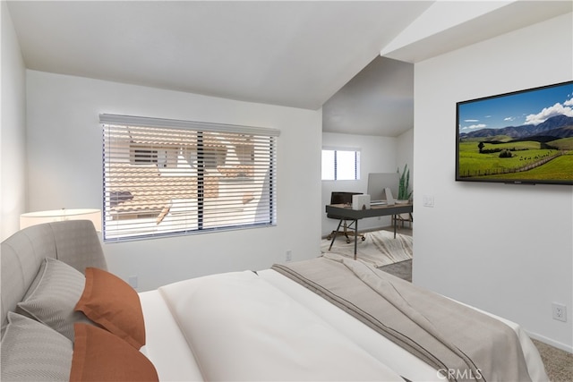 bedroom with carpet and vaulted ceiling