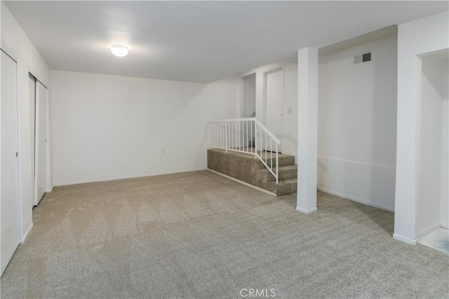 basement featuring light carpet