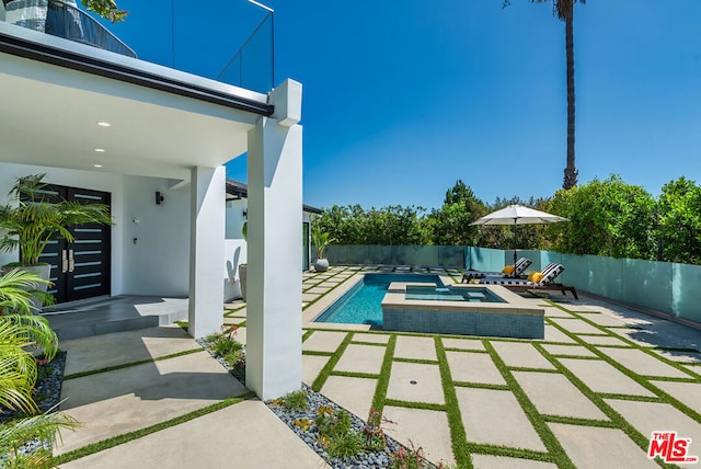 view of swimming pool with a patio and an in ground hot tub