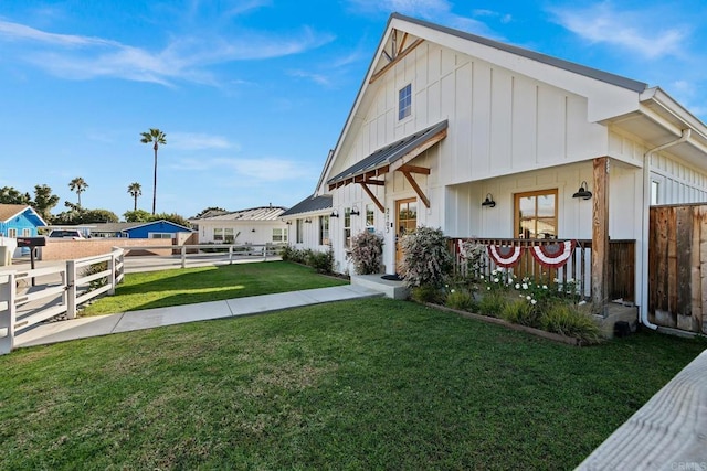 rear view of property with a yard