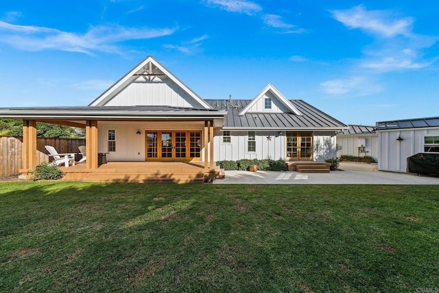 back of property featuring a lawn, a storage shed, a patio, and french doors