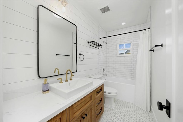 full bathroom featuring tile patterned flooring, shower / bath combination with curtain, vanity, and toilet