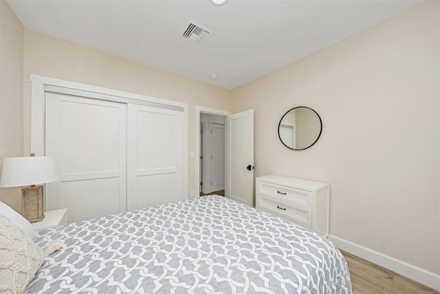 bedroom with a closet and light hardwood / wood-style flooring