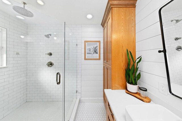 bathroom with vanity, tile patterned floors, walk in shower, and wooden walls