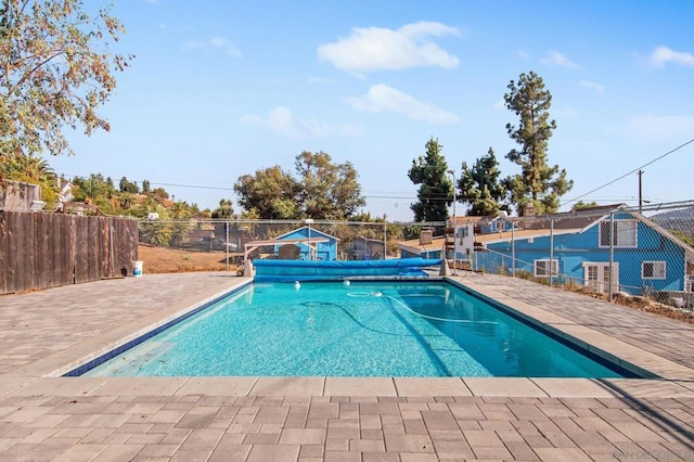 view of swimming pool with tennis court