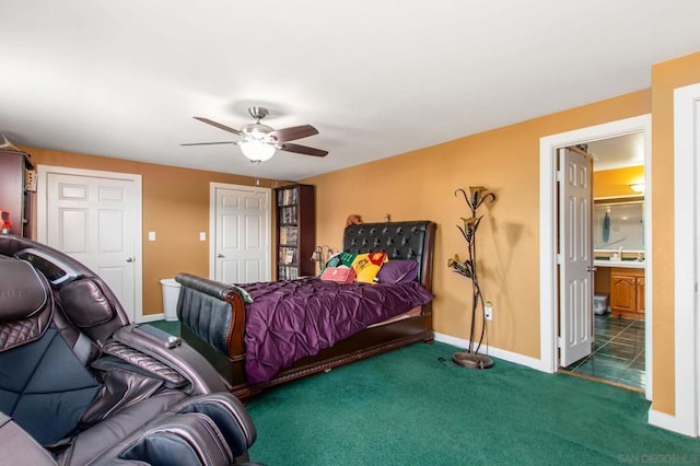 bedroom with ceiling fan, connected bathroom, and dark carpet