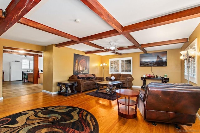 living room featuring beamed ceiling, ceiling fan, coffered ceiling, and hardwood / wood-style floors