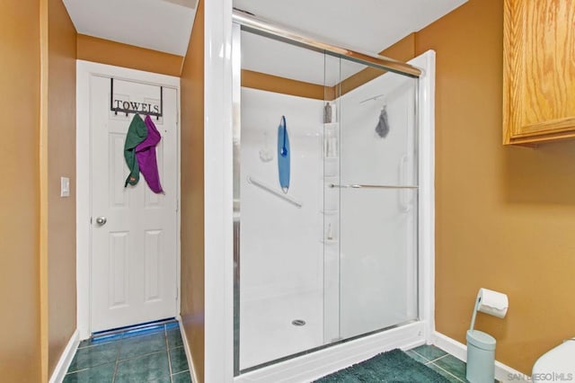 bathroom featuring tile patterned floors and a shower with shower door