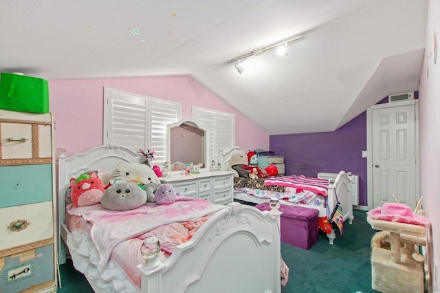 carpeted bedroom featuring lofted ceiling and rail lighting