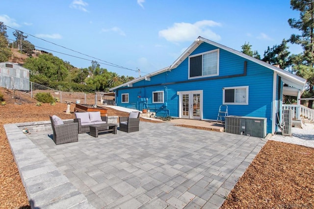 back of house featuring french doors, an outdoor living space, and a patio