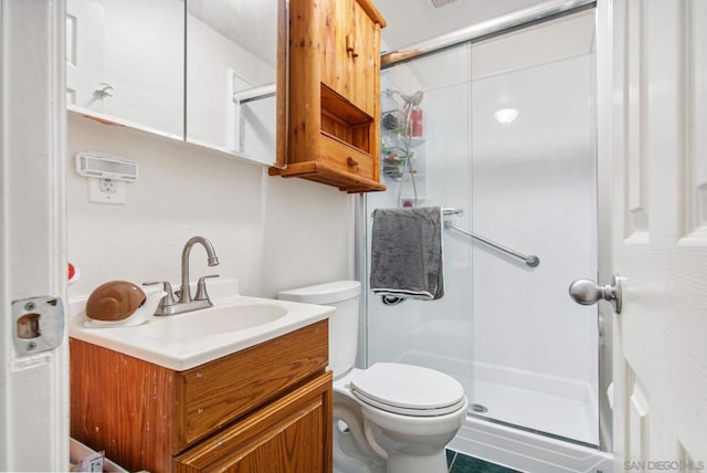 bathroom with vanity, toilet, and walk in shower