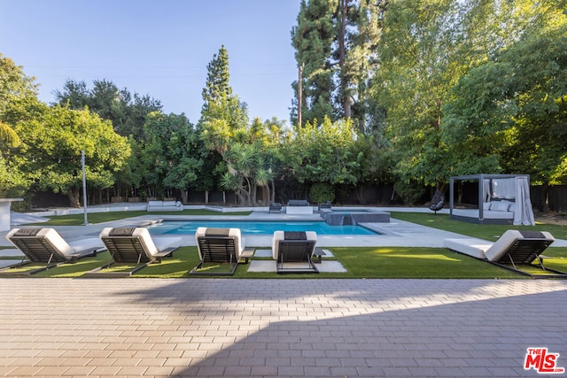 view of swimming pool featuring a yard and a patio