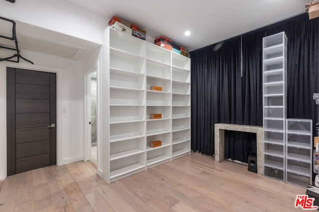 spacious closet with hardwood / wood-style flooring