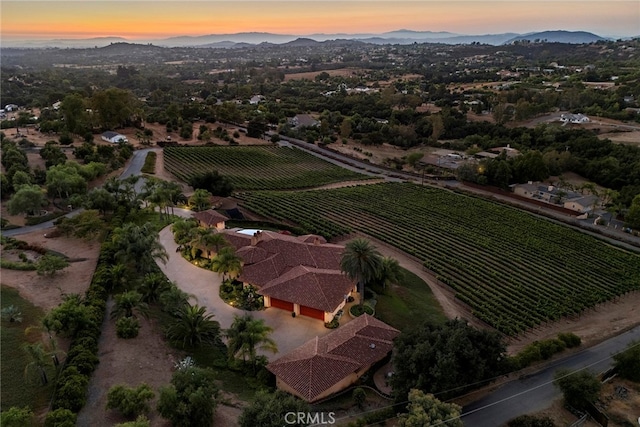 aerial view at dusk with a rural view and a mountain view