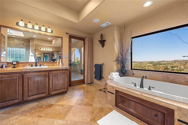 bathroom with a bath and vanity