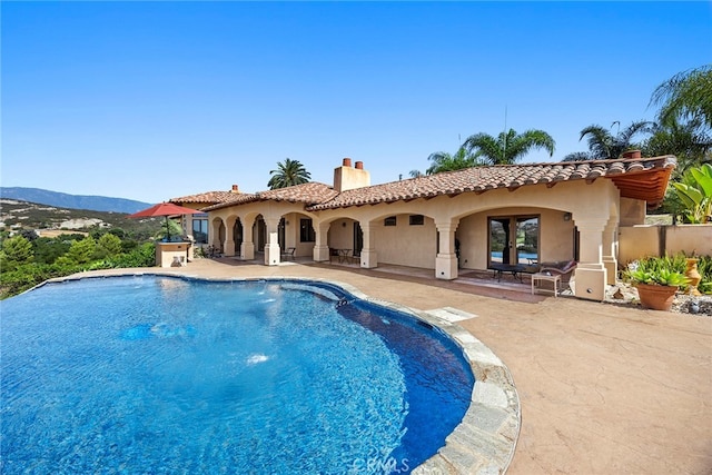 view of pool featuring a patio and a mountain view