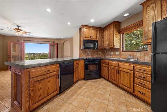 kitchen with ceiling fan, sink, a healthy amount of sunlight, and black appliances