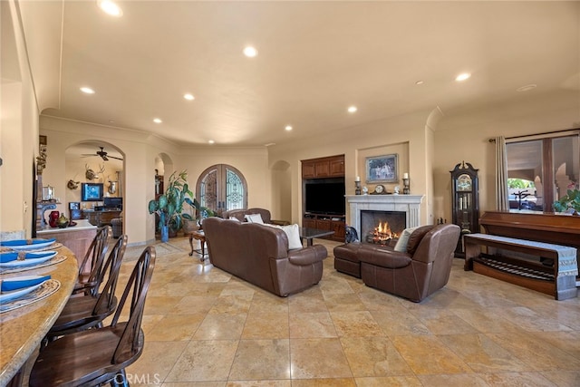 living room featuring ceiling fan and french doors