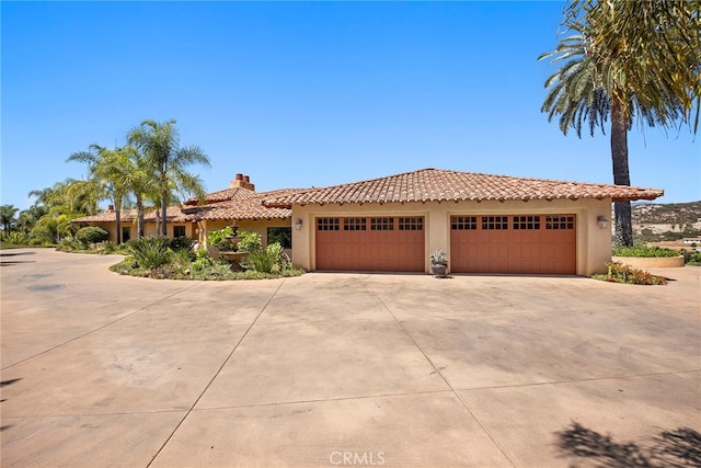 mediterranean / spanish home featuring a garage