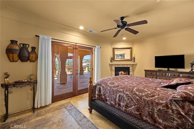 bedroom featuring access to outside, a fireplace, ceiling fan, and french doors