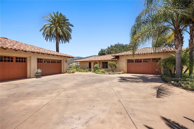 mediterranean / spanish home featuring a garage