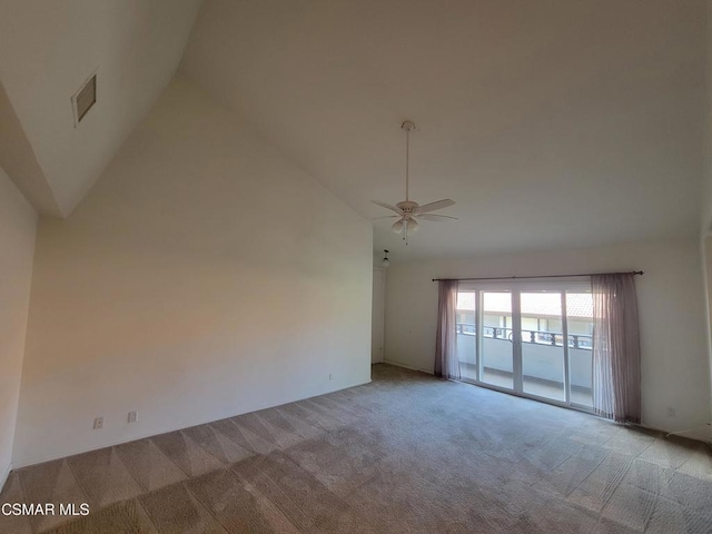 carpeted empty room with ceiling fan and high vaulted ceiling