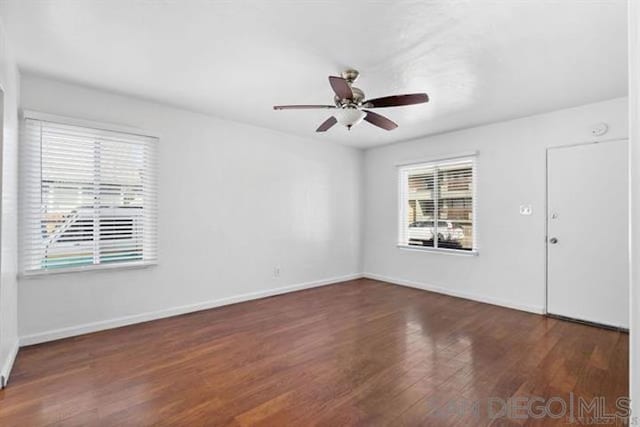 unfurnished room featuring ceiling fan and dark hardwood / wood-style floors