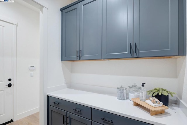 laundry room with light wood-type flooring