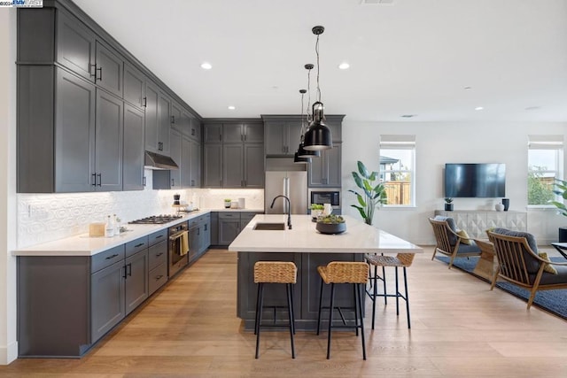 kitchen with plenty of natural light, light wood-type flooring, and sink