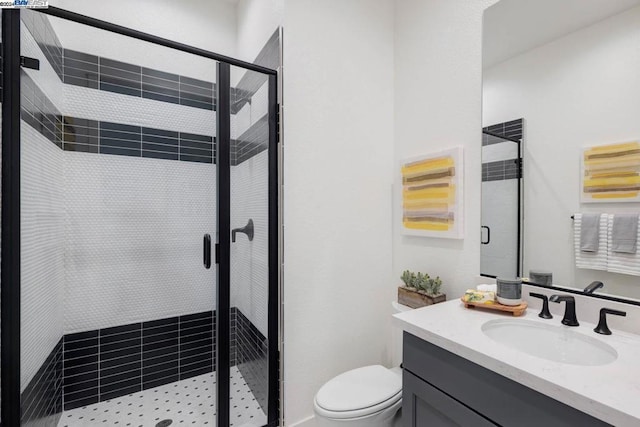 bathroom featuring vanity, toilet, and walk in shower