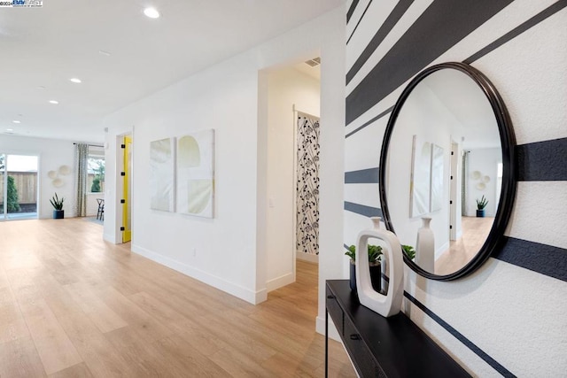 hallway with light hardwood / wood-style flooring