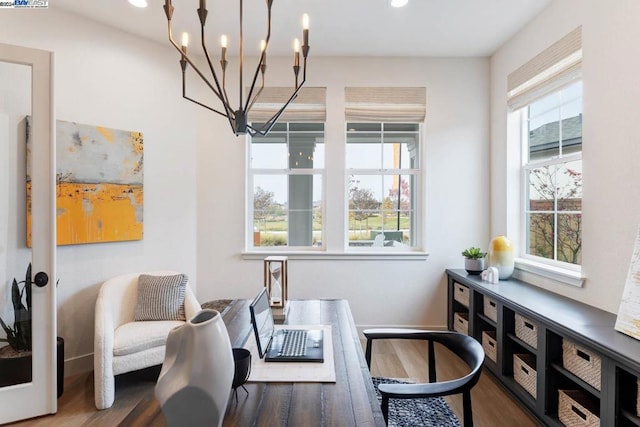 sitting room featuring dark wood-type flooring and a chandelier