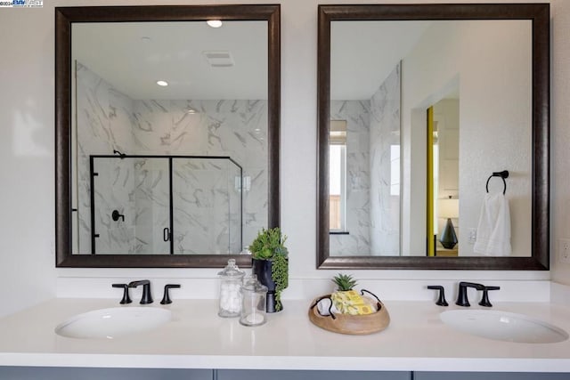 bathroom featuring vanity and a shower with shower door