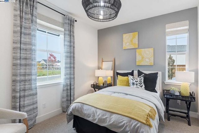 bedroom with carpet flooring and multiple windows