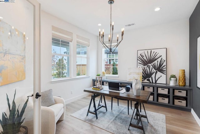 office area featuring light hardwood / wood-style floors and an inviting chandelier