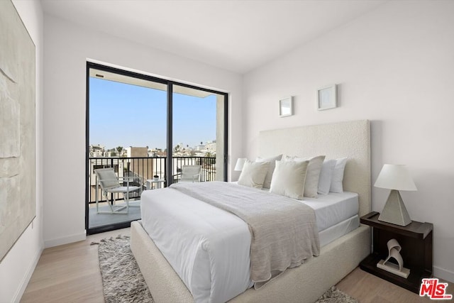 bedroom with access to outside and light hardwood / wood-style flooring