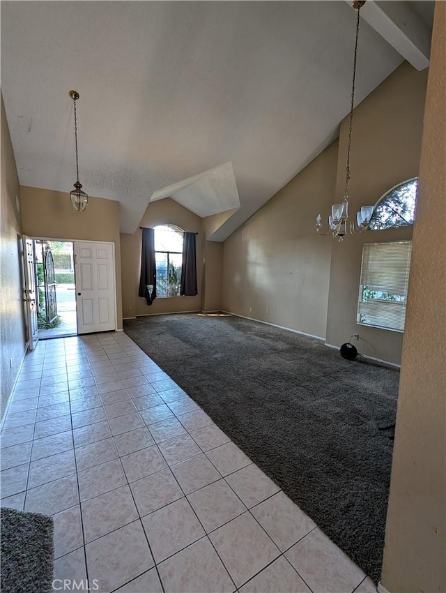 interior space with lofted ceiling with beams and a chandelier