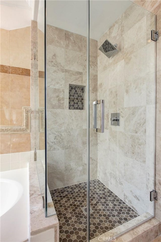 bathroom with shower with separate bathtub