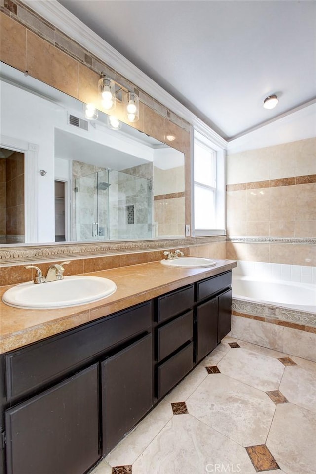 bathroom featuring vanity, independent shower and bath, and ornamental molding