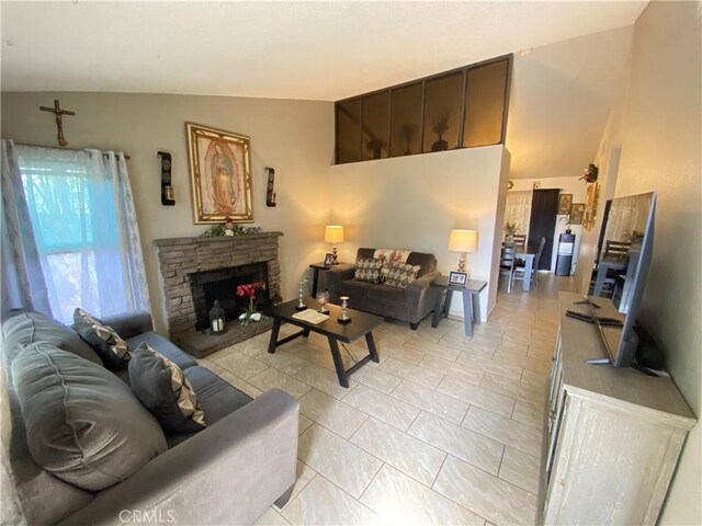 tiled living room featuring vaulted ceiling and a fireplace