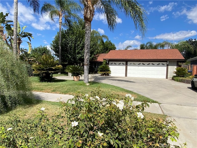 view of front of home with a garage and a front lawn