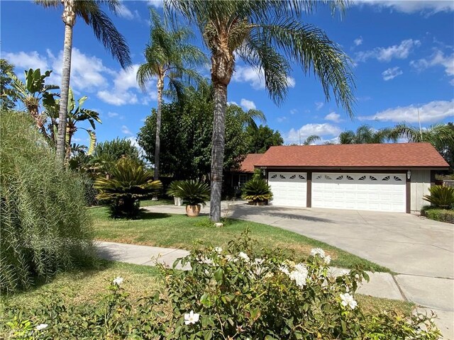 view of front of house with a front yard and a garage