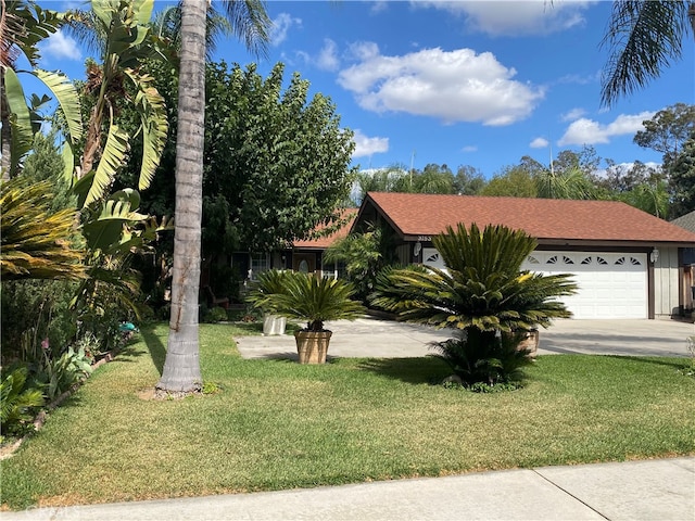 view of front facade featuring a front yard and a garage